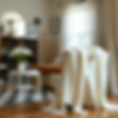 Elegant white knit cardigan draped over a chair in a stylish living room.