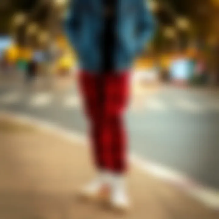 Casual Look Featuring Red Checkered Trousers Fashionable combination of red checkered trousers with casual sneakers and a denim jacket.