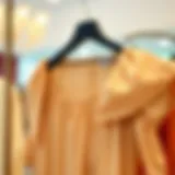 Elegant blouse with elastic sleeves displayed on a hanger