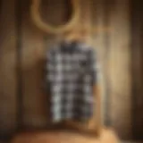 Classic plaid flannel shirt displayed on a rustic wooden background.