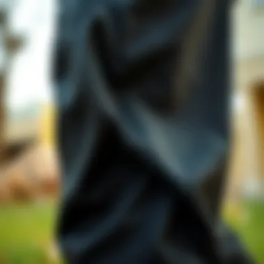 Close-up of fabric texture and design details of black jogger pants